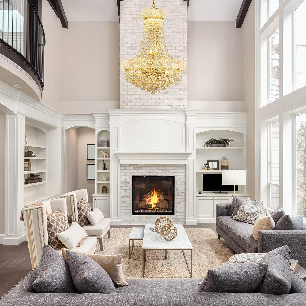 Luxurious living room with a fireplace, gray sofa, and gold chandelier.