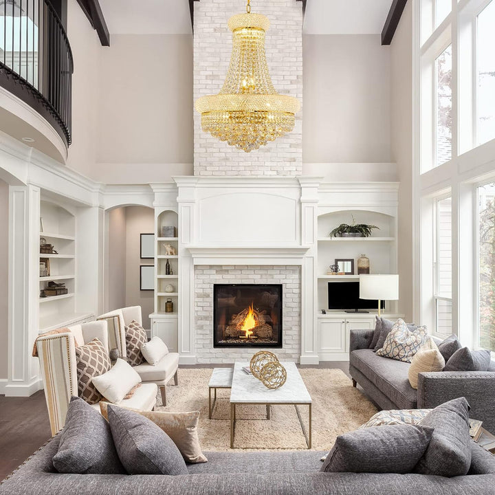 Luxurious living room with a fireplace, gray sofa, and gold chandelier.