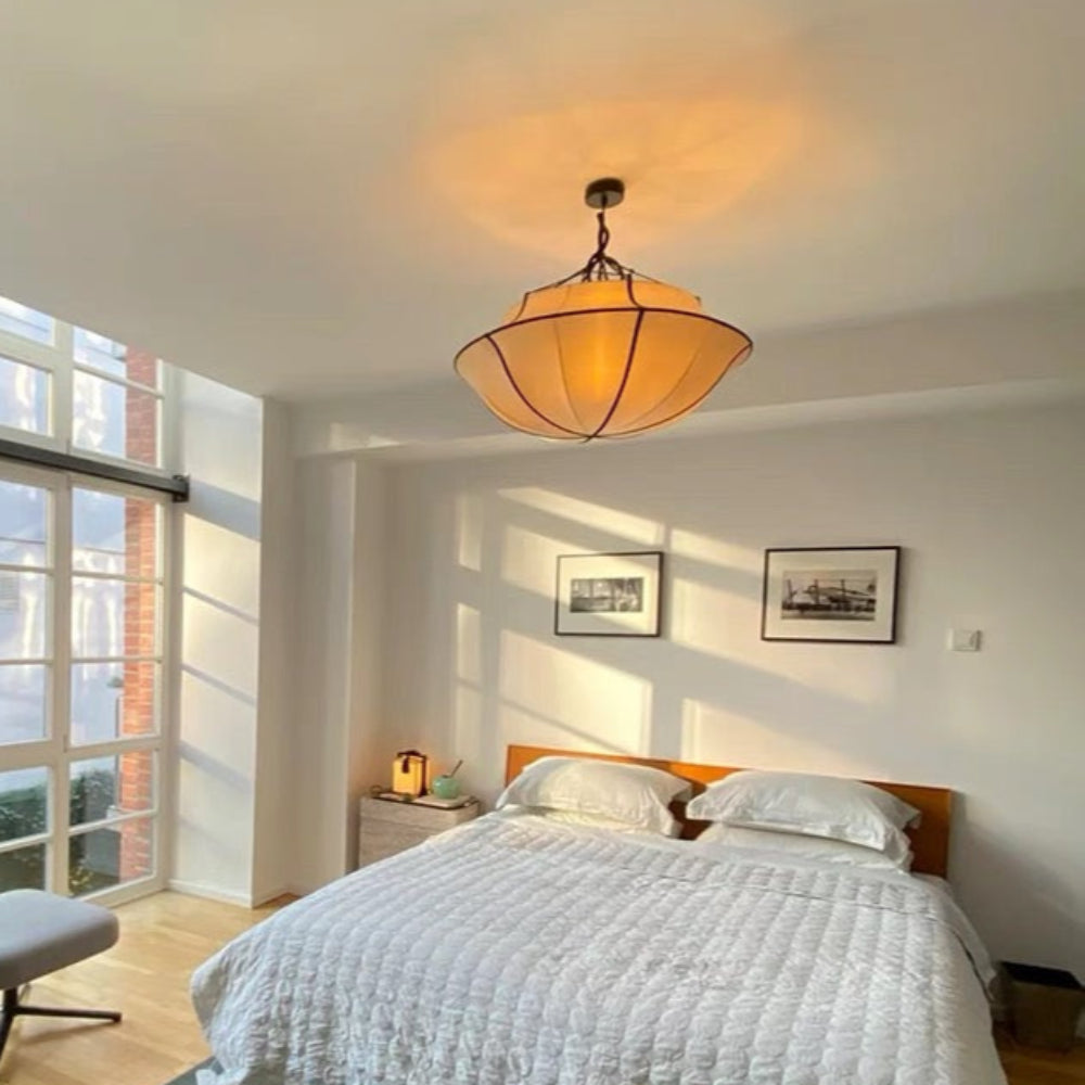 Modern bedroom with a bed, nightstands, and large windows.