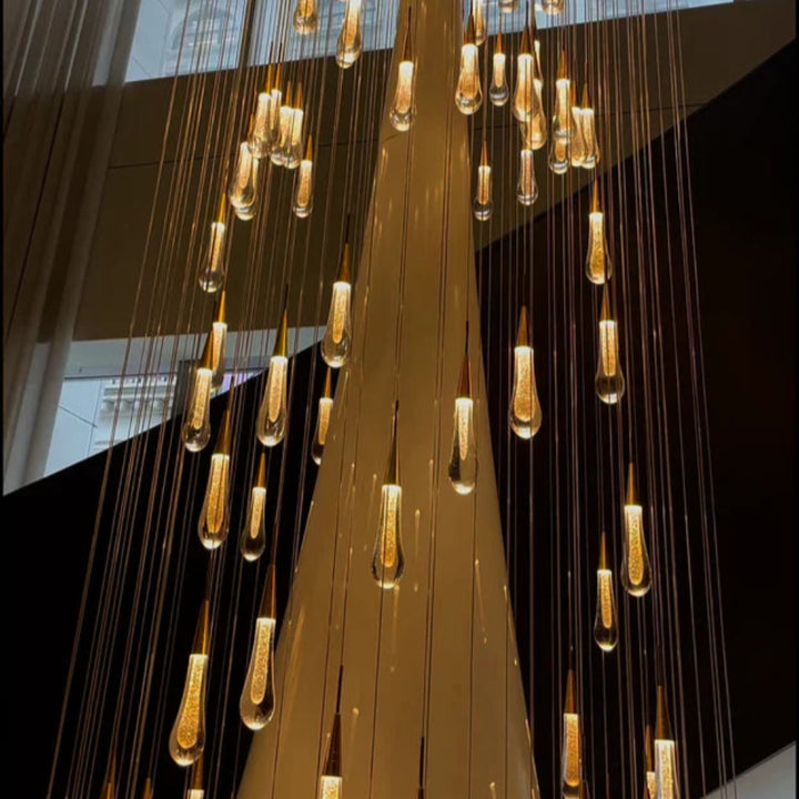 Modern chandelier with hanging lights in a room with large windows