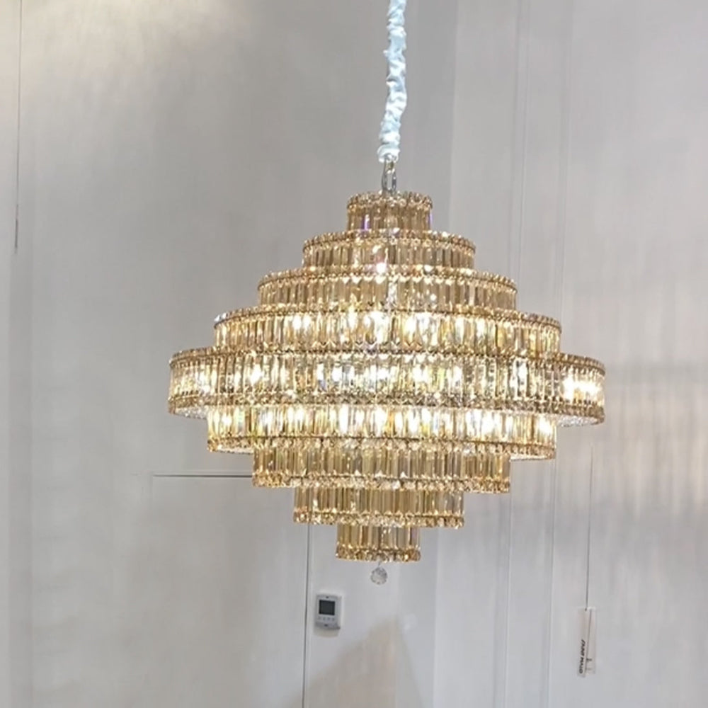 Gold chandelier hanging against a white wall