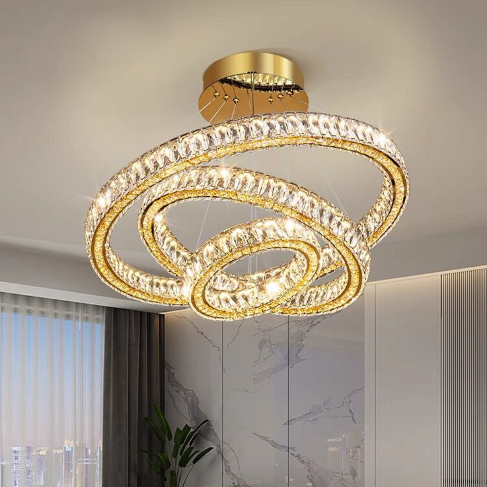 Modern chandelier hanging above a living room with a sofa and coffee table.