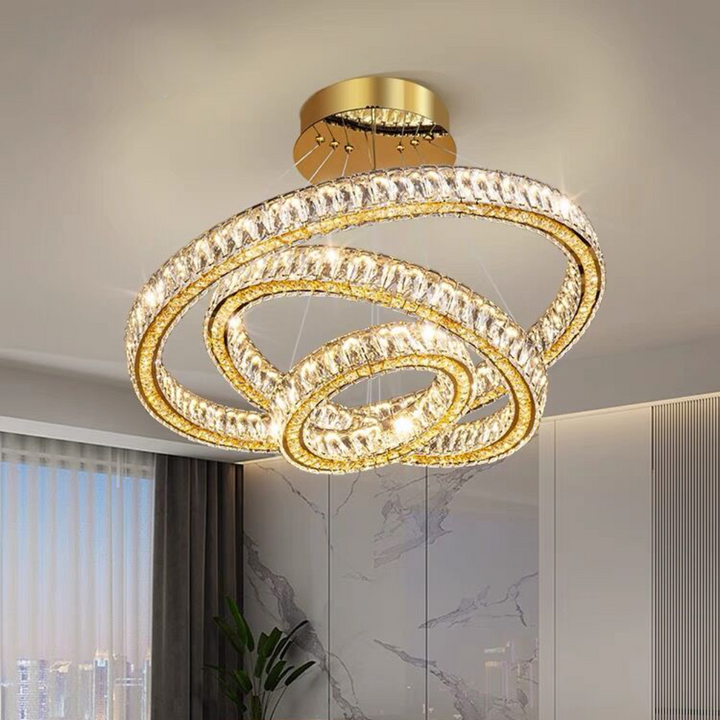 Modern chandelier hanging above a living room with a sofa and coffee table.
