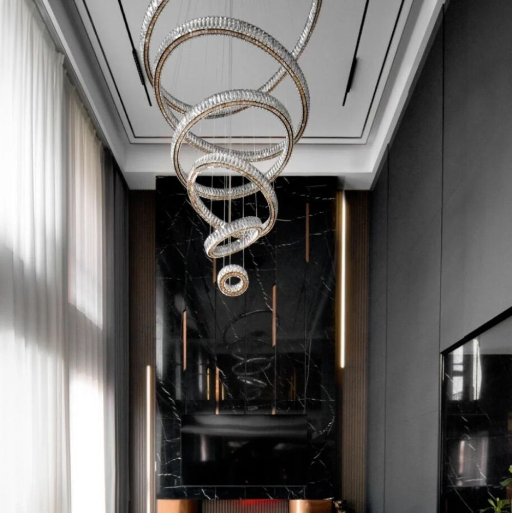Modern living room with a stylish chandelier, beige sofas, and a fireplace.