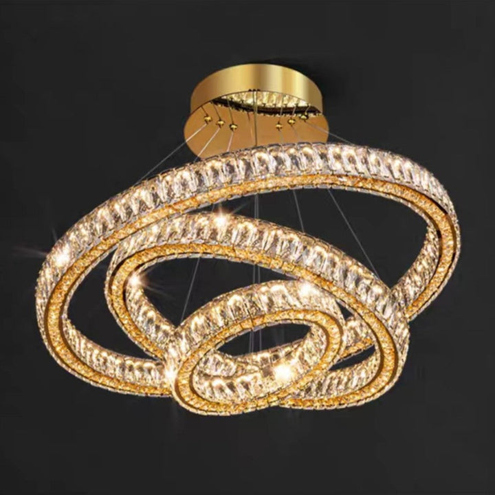 Gold chandelier with interlocking rings on a black background