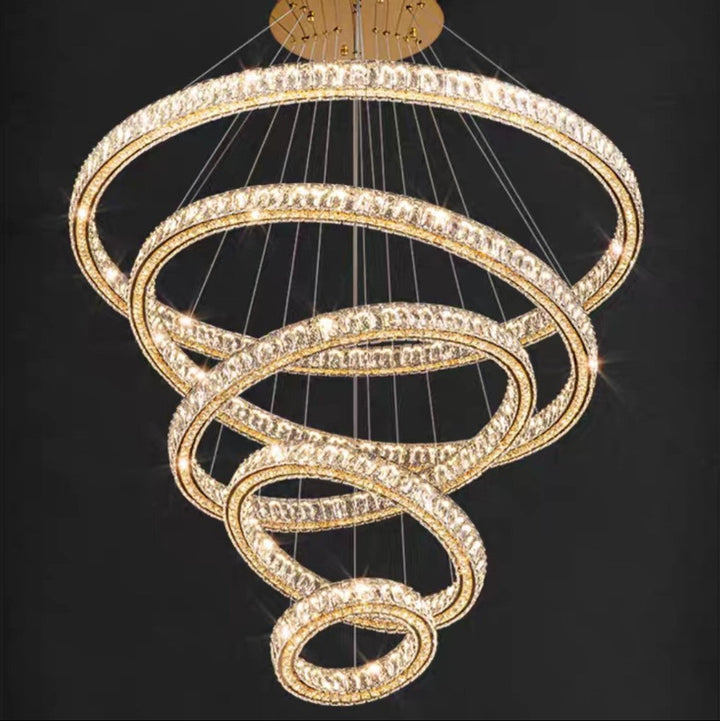 Chandelier with multiple gold rings on a black background
