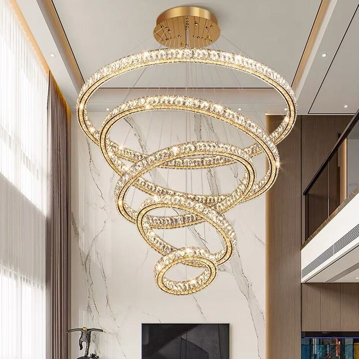 Modern chandelier with gold finish and crystal elements in a stylish interior setting.