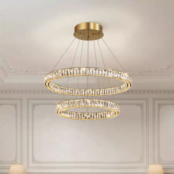 Modern living room with a luxurious chandelier and gray sofa.
