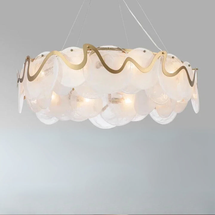 Decorative ceiling light fixture with wavy glass design on a gray background