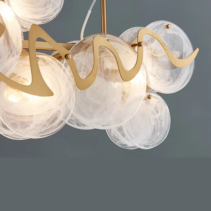 Chandelier with gold fixtures and glass globe lights on a dark background
