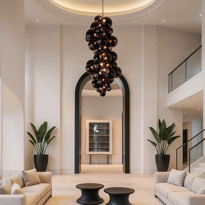 Modern interior with a chandelier, potted plants, and a staircase.