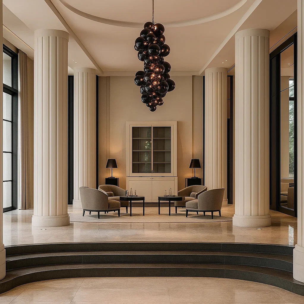 Luxurious interior with columns, modern furniture, and a chandelier.