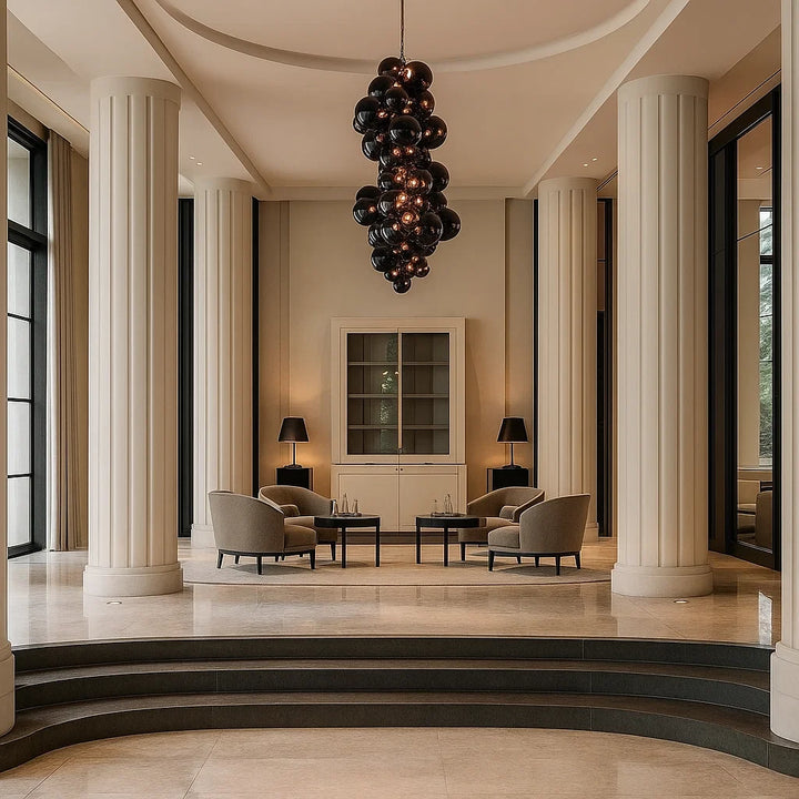 Luxurious interior with columns, modern furniture, and a chandelier.