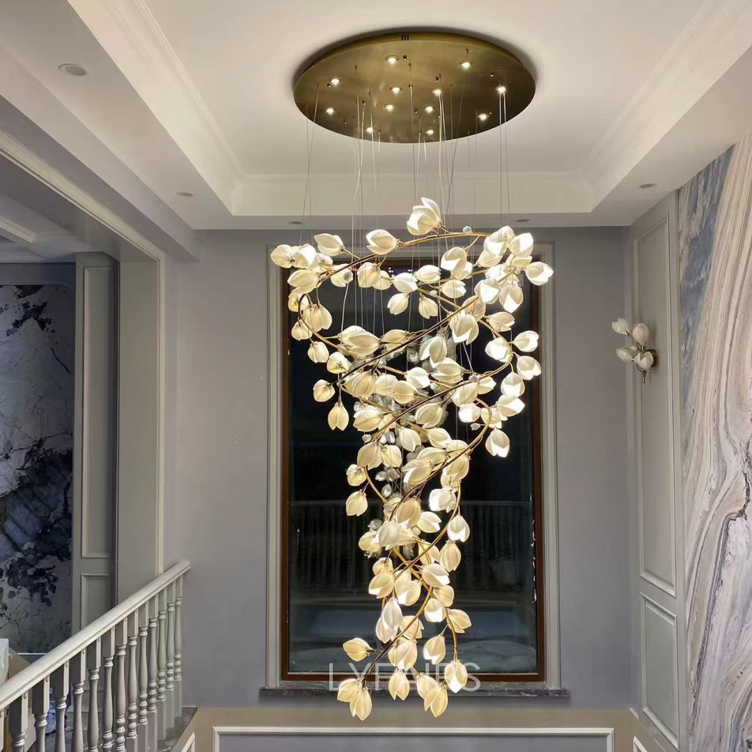 Modern chandelier hanging in a stylish interior setting with a mirror and staircase.