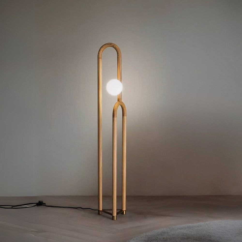 Modern floor lamp with a single bulb on a plain background