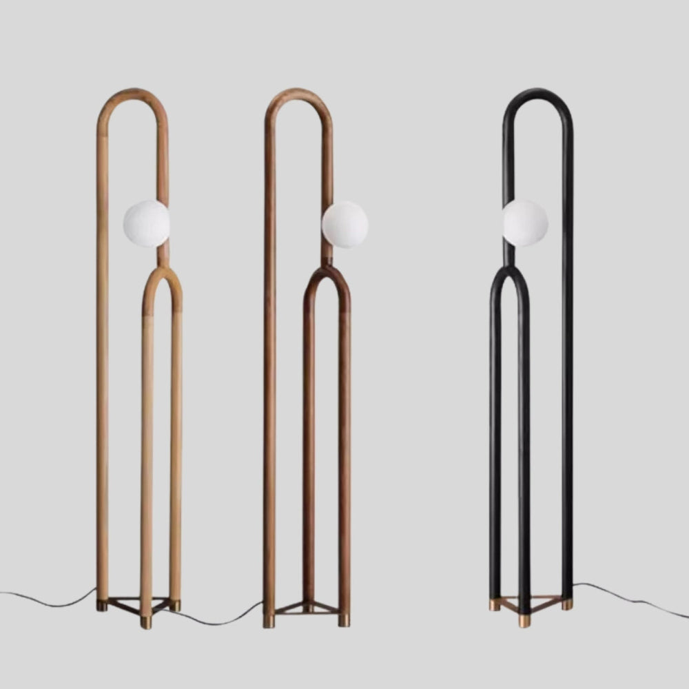 Three floor lamps with different metal finishes on a light gray background