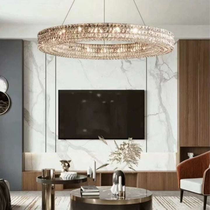 Modern living room with a chandelier, TV, and decorative items.