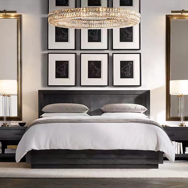 Modern bedroom with a bed, nightstands, and wall art.