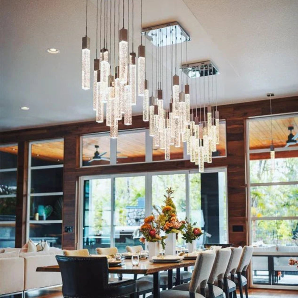 Dining room with a SQUATU Crystsal chandelier, table, and chairs.