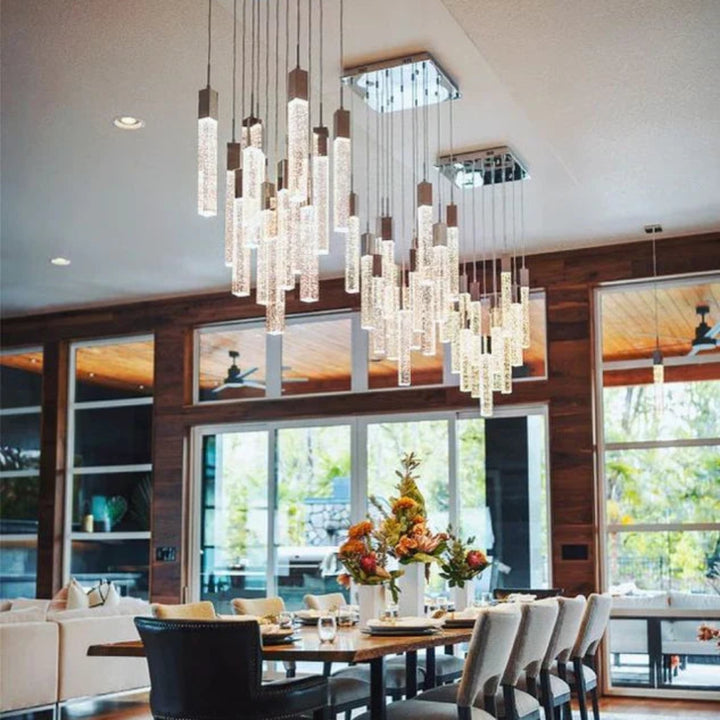 Dining room with a SQUATU Crystsal chandelier, table, and chairs.
