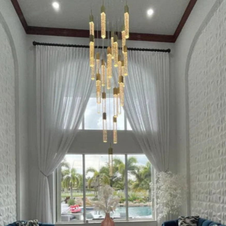 Modern living room with modern sofas, a Squatu chandelier, and a large window.