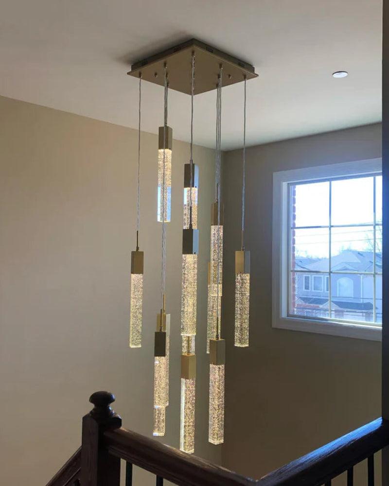 Modern chandelier hanging in a room with a window in the background