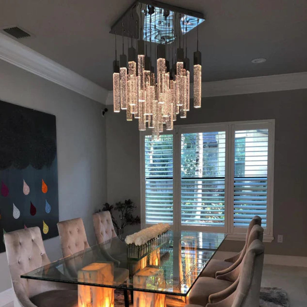Dining room with a glass table and modern chandelier SQUATU Crystsal Pendant Lighting